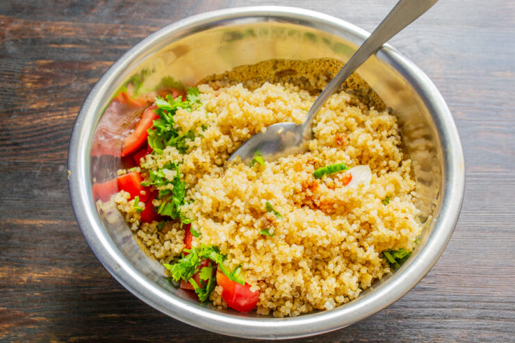 Quinoa cocida sobre una mezcla de verduras frescas troceadas en un bol