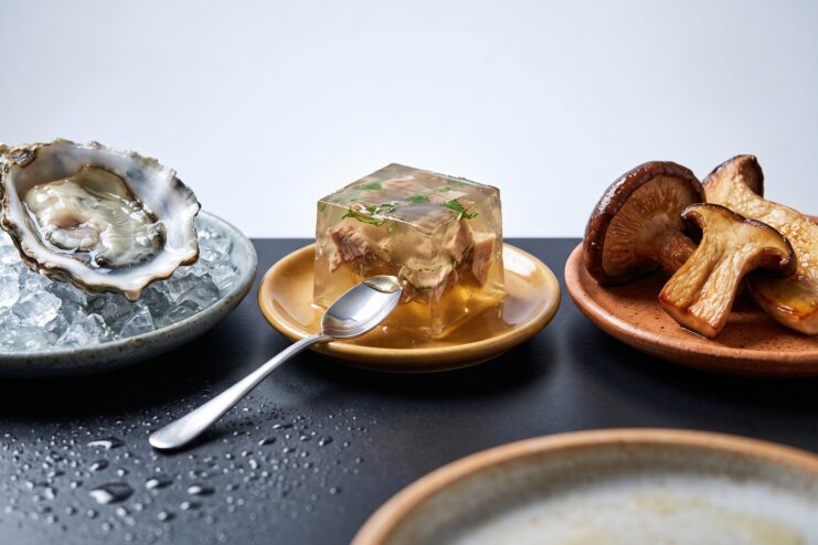 Ostra sobre hielo, cubo de gelatina y setas shiitake fritas mostrando distintas texturas