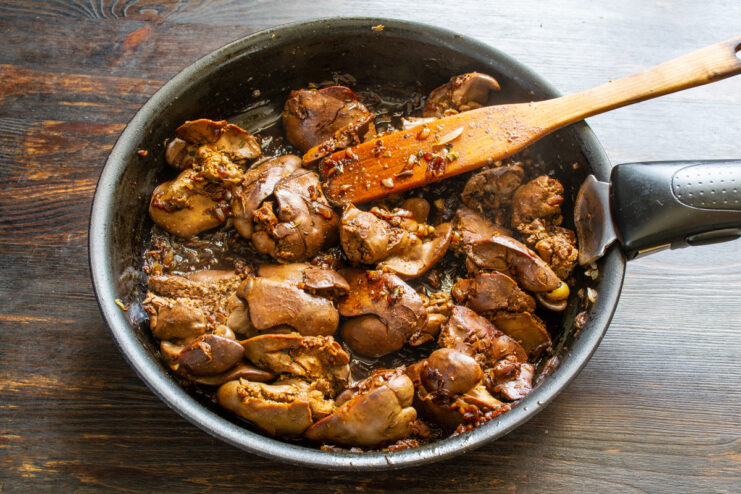 Hígados fritos listos Hígados de pollo fritos en sartén tras reducir el vino